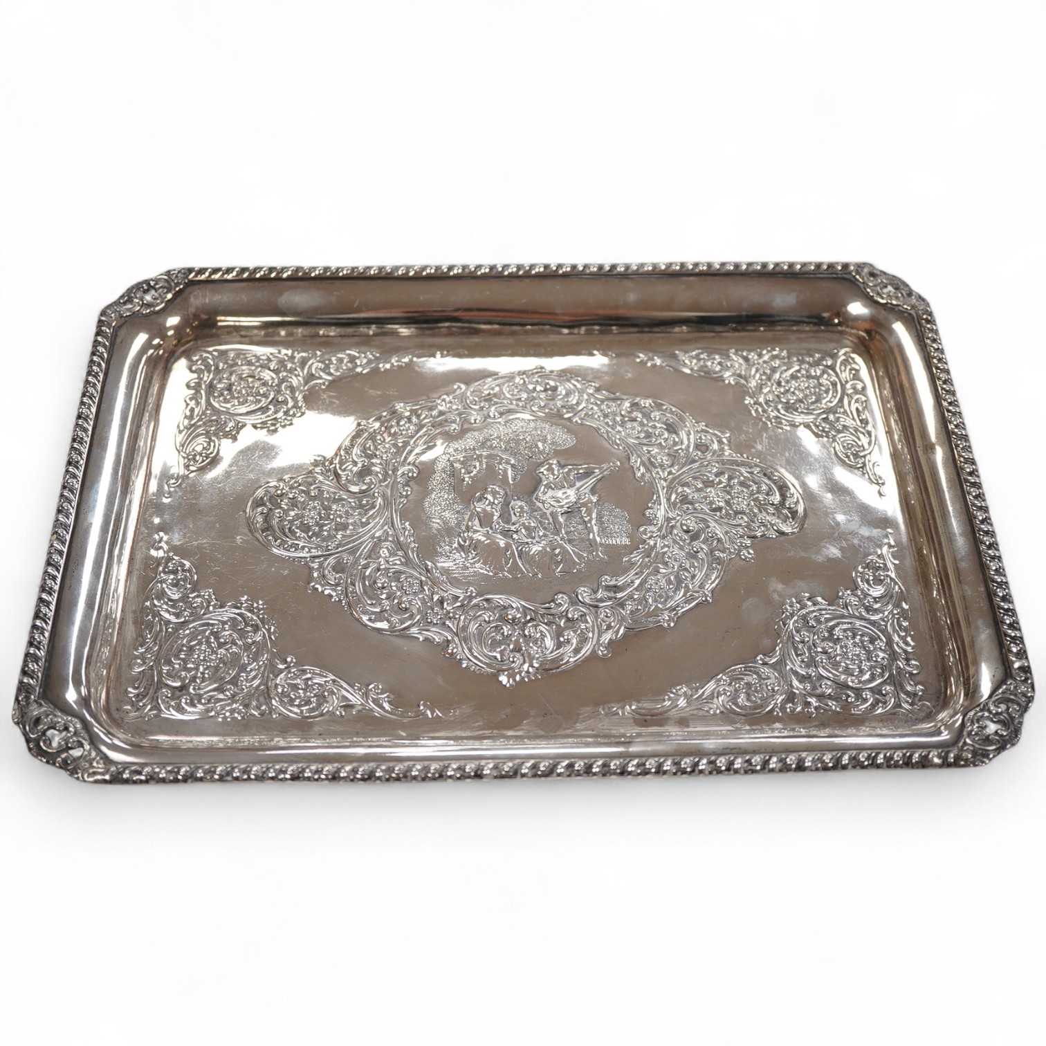 An Edwardian embossed silver dressing table tray, by Henry Matthews, Birmingham, 1901, length 32.1cm, 16.8oz.